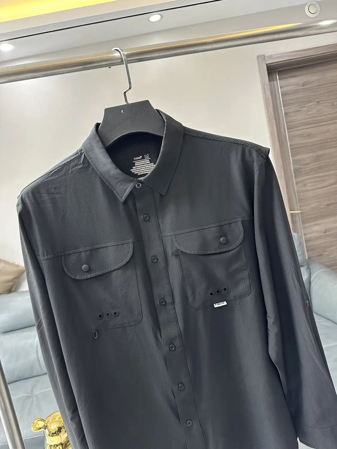 Men’s tactical outdoor long sleeve shirt in black with two chest pockets and subtle textured fabric.