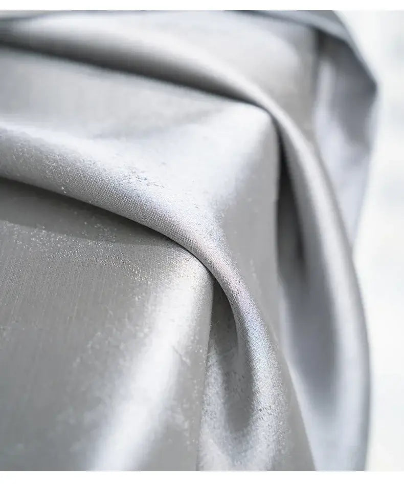 a smooth metallic silver blackout fabric with subtle sheen and gentle folds for living room curtains para la sala with tassel tieback beads