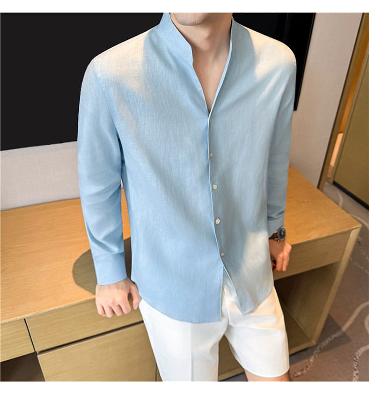 Light blue men’s linen mandarin collar shirt with long sleeves and button-up front.