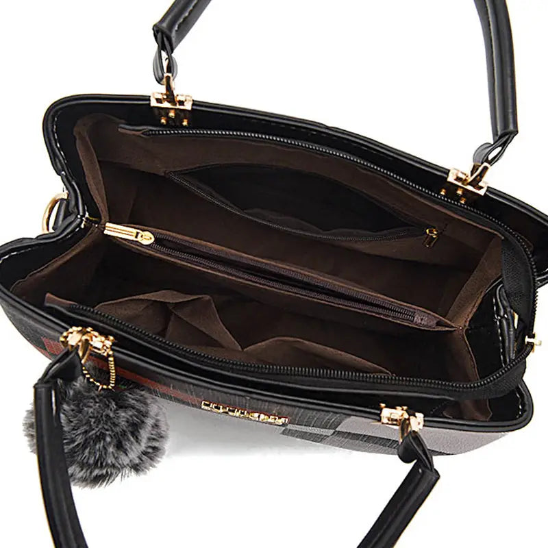 Black crossbody handbag style1 style2 in pu leather featuring a black plaid pattern gold-tone hardware accents and a fluffy gray pom-pom attached to one handle.