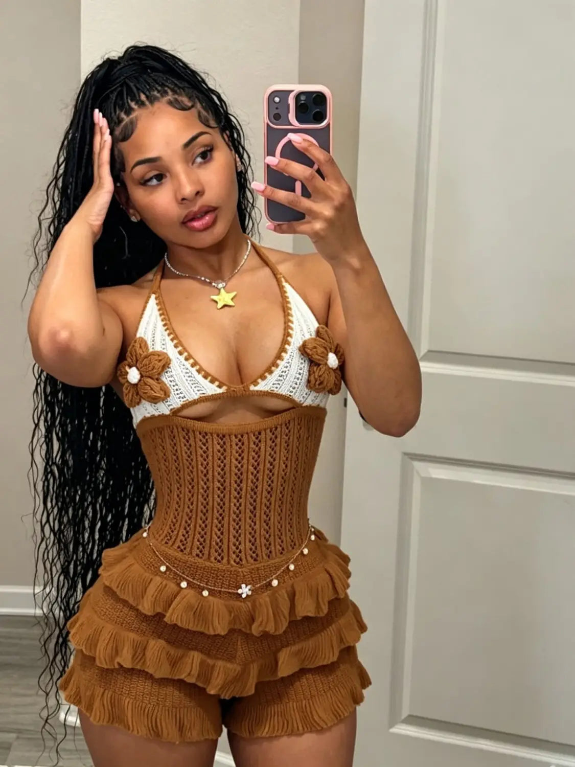 Brown knitted ruffle halter romper playsuit featuring a corset-style top with a white crochet halter neckline and floral embellishments.