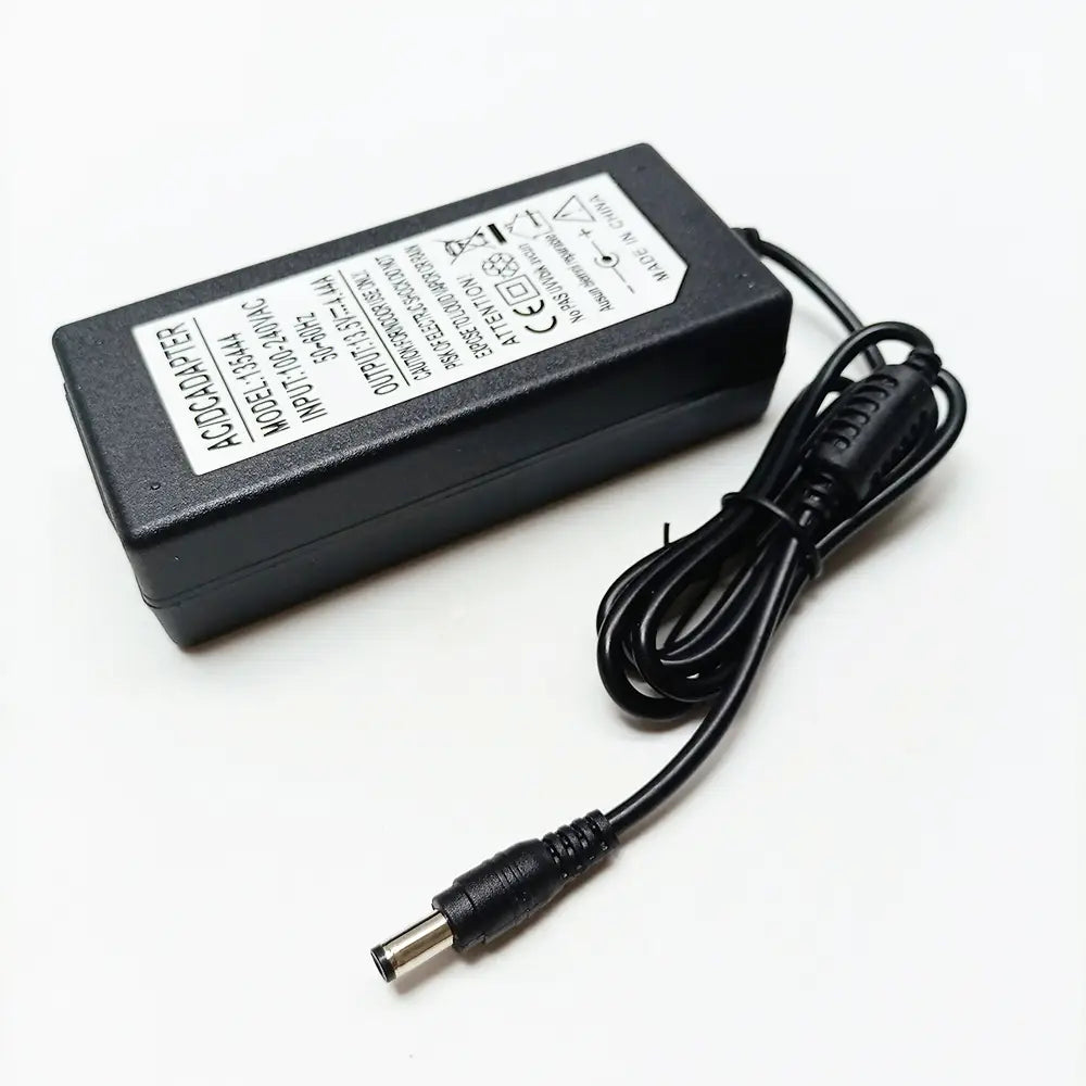 Black plastic ac adapter with a coiled power cord and cylindrical dc output plug for Fiber Fusion Splicer Charger by Signal Fire made in Mainland China.