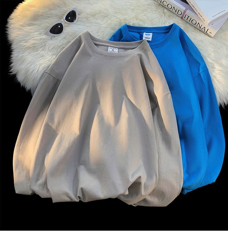 Beige oversized long sleeve blank t-shirt made of cotton with a relaxed fit and round neckline.
