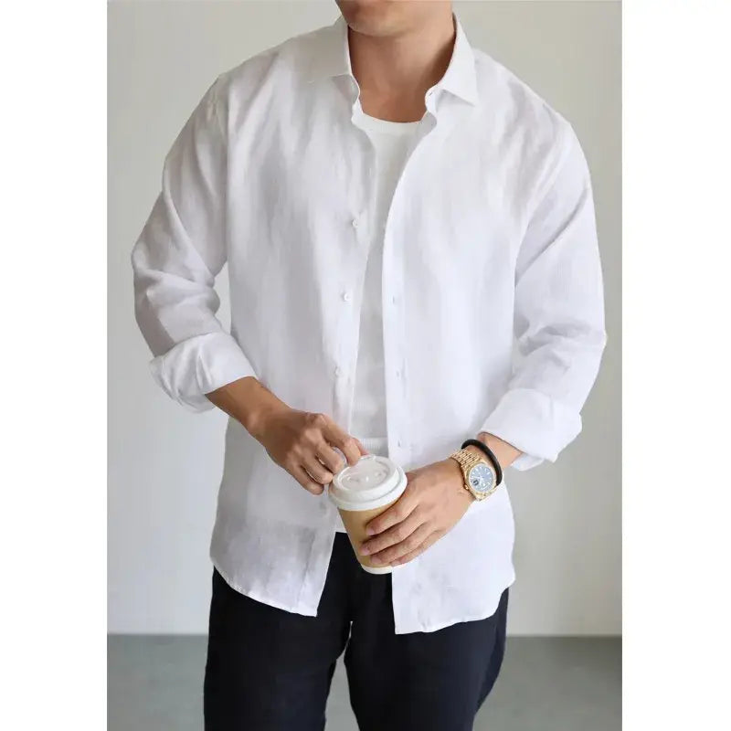white button-down shirt with a relaxed fit and rolled-up sleeves made of cotton linen for casual wear