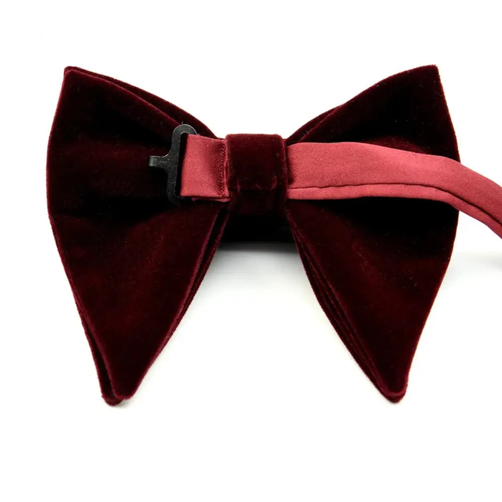 A rich burgundy velvet bow tie with a matching satin band and black metal clasp designed as formal neckwear gift.