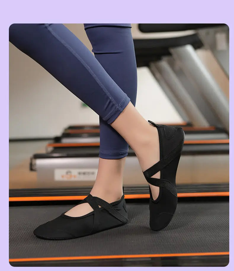Black canvas women yoga shoes ballet flats with crisscross straps and anti-slip low-profile fitness design.