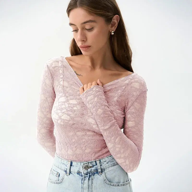 A delicate pink lace long-sleeved crop top with a flattering v-neckline designed as women aesthetic clothes for a stylish and elegant look.