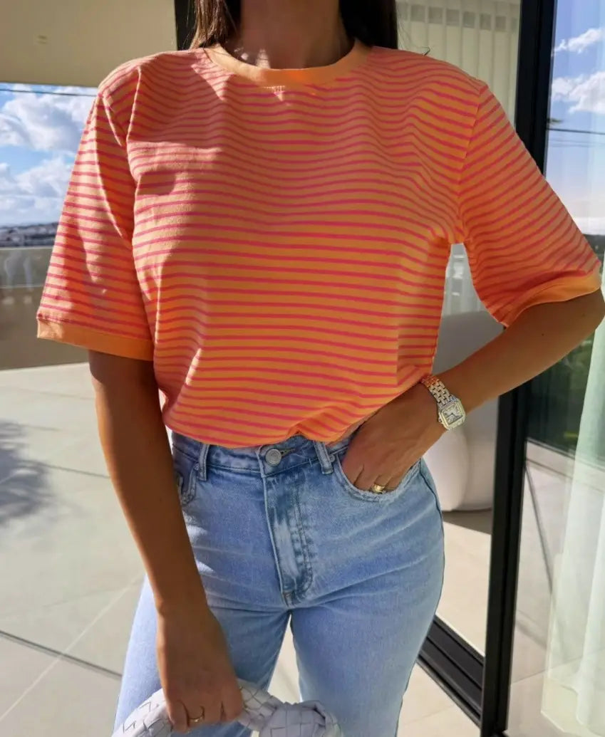 A vibrant orange and coral striped short sleeve t shirt with a relaxed fit perfect for casual summer wear.