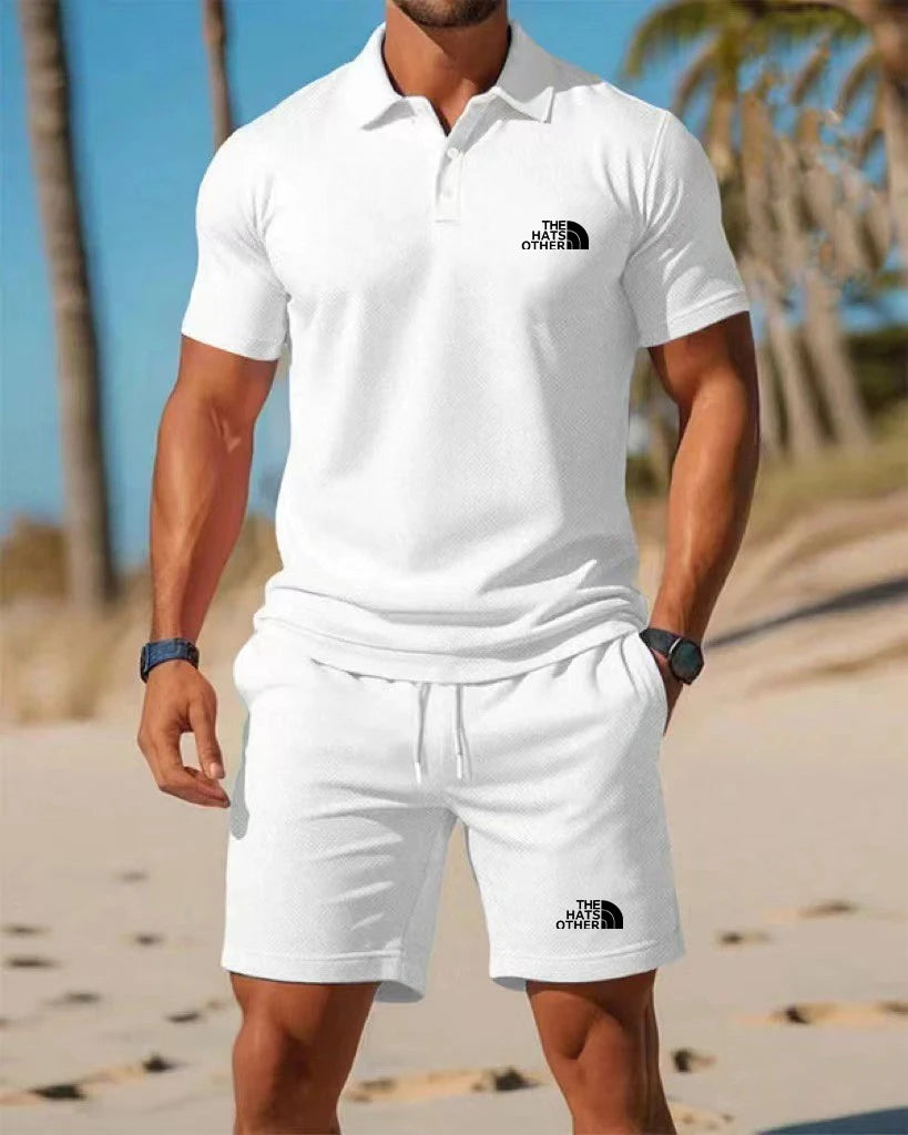 White north face men’s knit polo shirt with black logo on the chest made from breathable fabric for casual wear.