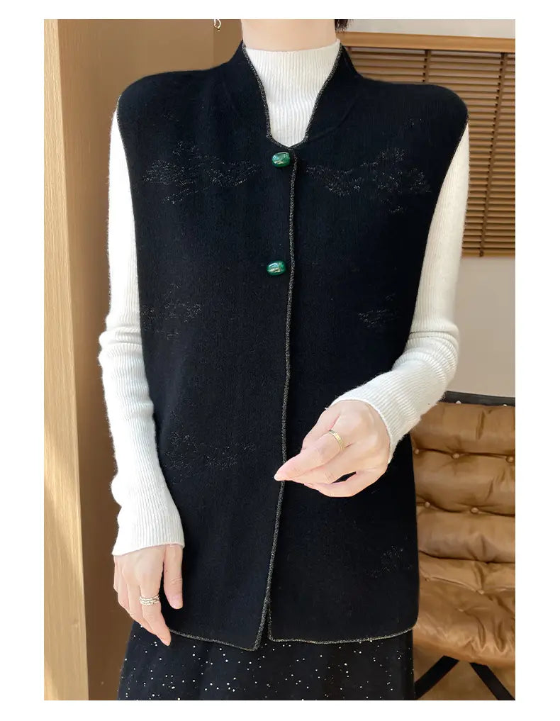 Black wool embroidered vest for women featuring a knitted sleeveless design with subtle patterns and green button closures.
