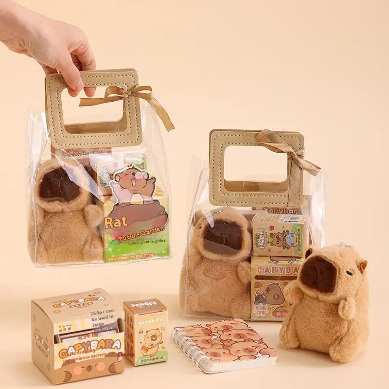 Niedriges, braunbeiges Plüsch-Capybara mit dunkelbrauner Schnauze und weicher, flauschiger Textur, enthalten in einem kawaii Geschenkartikel-Schreibwaren-Set zum Thema Capybara.