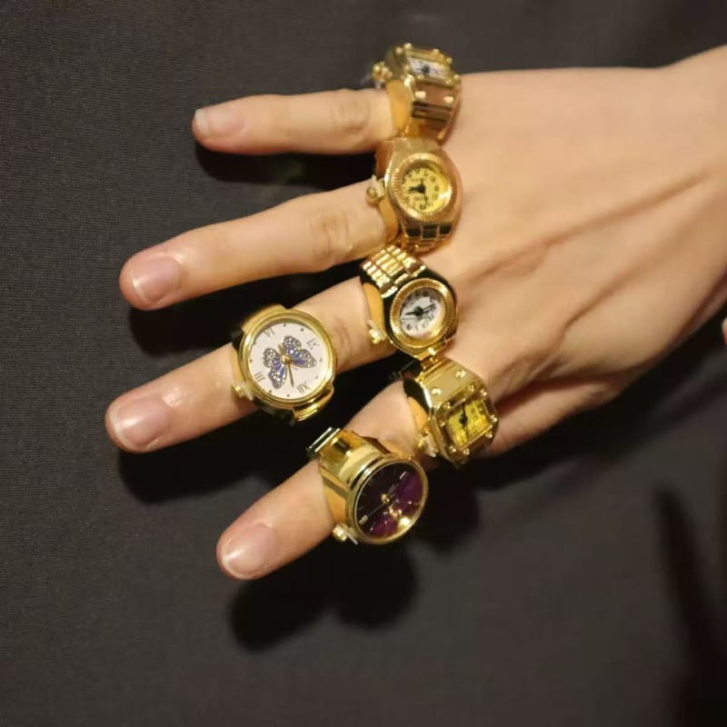 Gold-toned stainless steel watch rings featuring varied face designs including butterfly and solid-colored dials, ideal as cute jewelry.