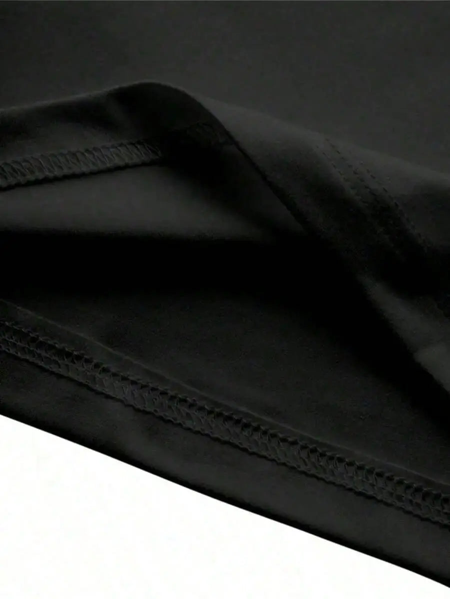 black fabric with neat uniform stitching along the edge of an oversized men short sleeve graphic print t shirt