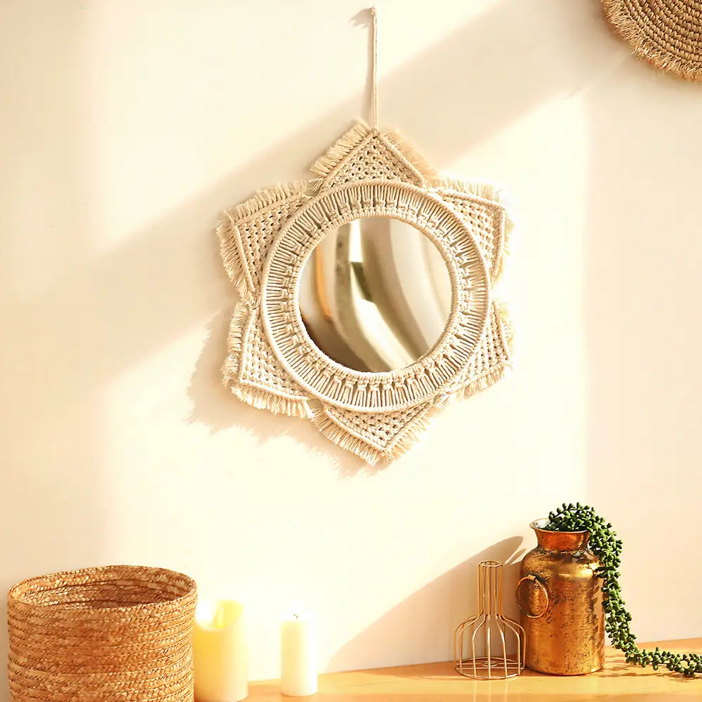 beige macrame wall mirror with a circular reflective center and fringed star-shaped woven frame for living room home decor.