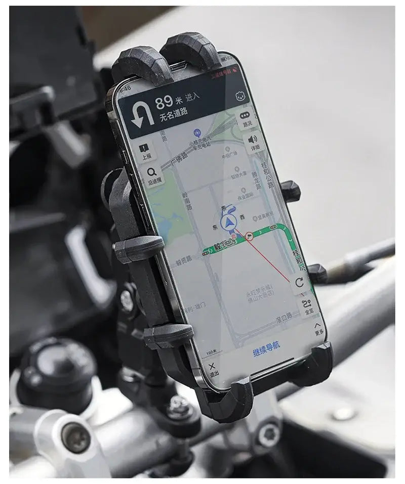 Black motorcycle wireless charging phone mount made of durable material holding a smartphone displaying navigation.