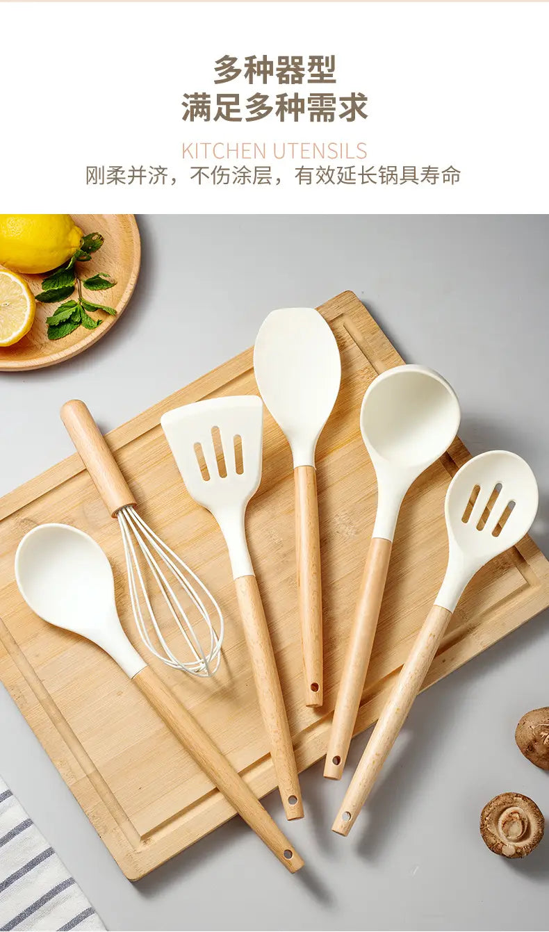 set of white silicone kitchen utensils with wooden handles including spoons spatulas and a whisk for cooking and baking.