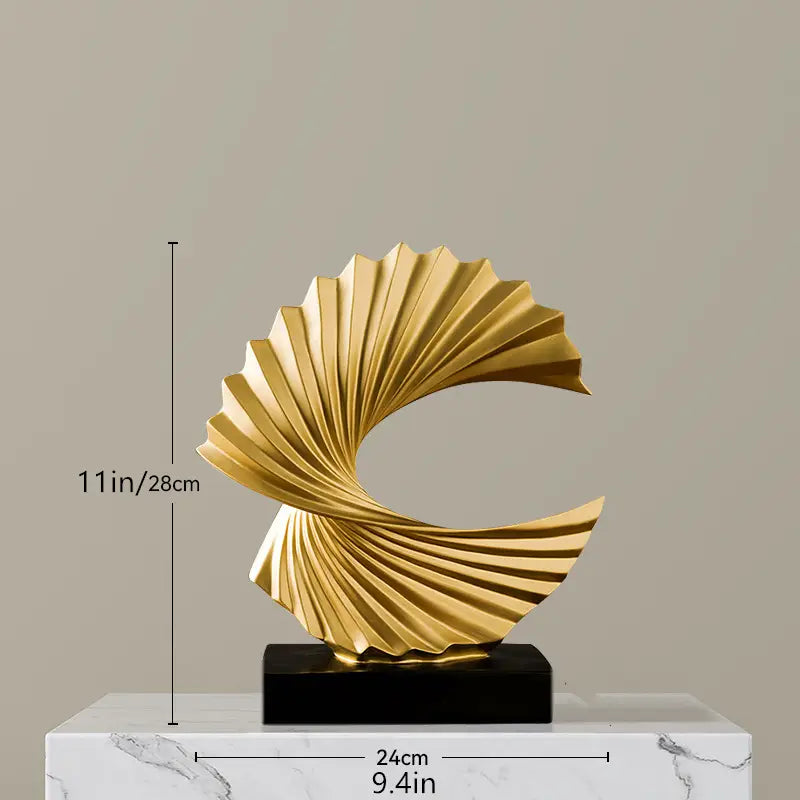 Art deco gold wave sculpture tabletop decor featuring a golden fan-like abstract design with a sleek metallic finish and spiral pattern.