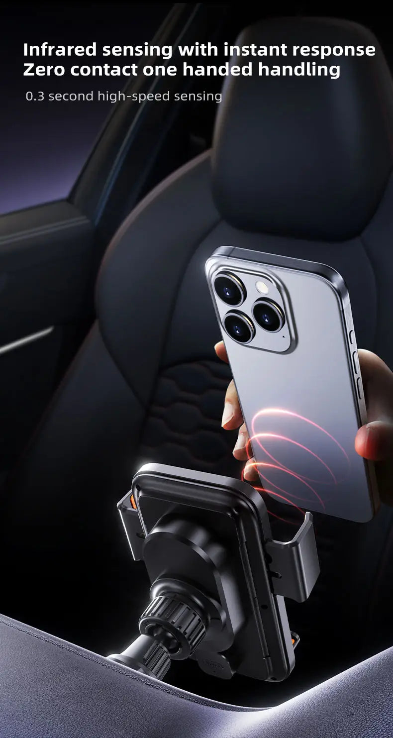 Silver iPhone 13 Pro with triple-camera system and glass back held above a black wireless car phone charger mount 15w.