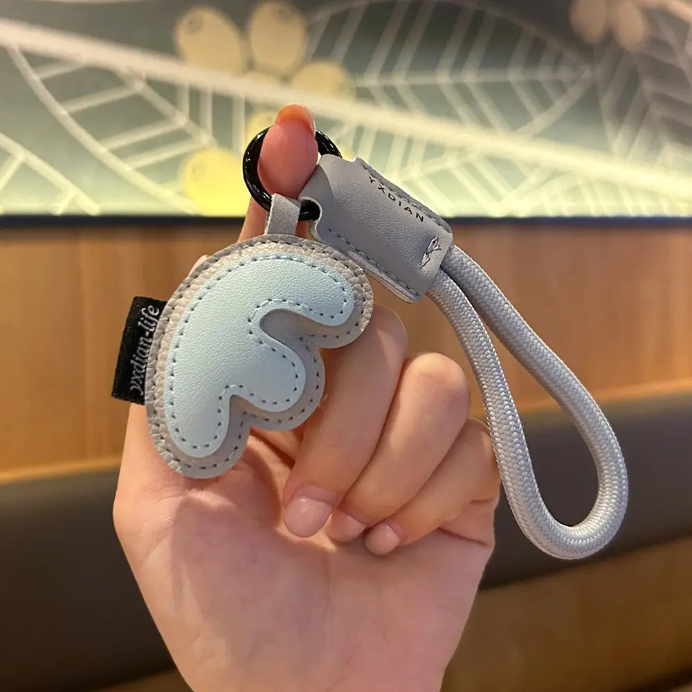 light blue leather initial keychain letter wristband charm with a cloud-shaped charm and gray braided strap