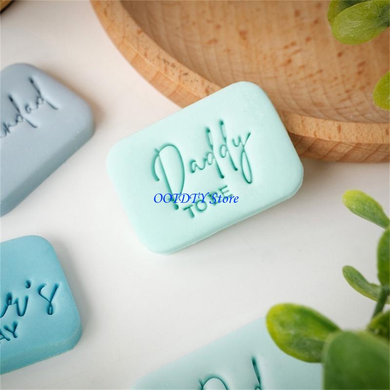 a mint green rectangular soap bar embossed with daddy to be in cursive script created using a father’s day cookie cutter and fondant stamp designed for gift making and baking projects