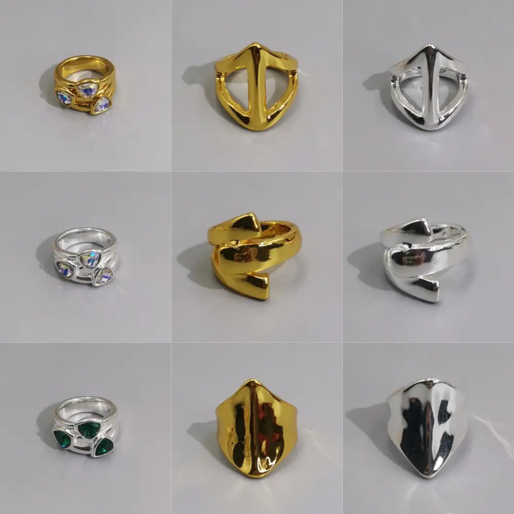 Geometric open ring in silver and gold metal featuring faceted gemstone accents on gold and silver bands.