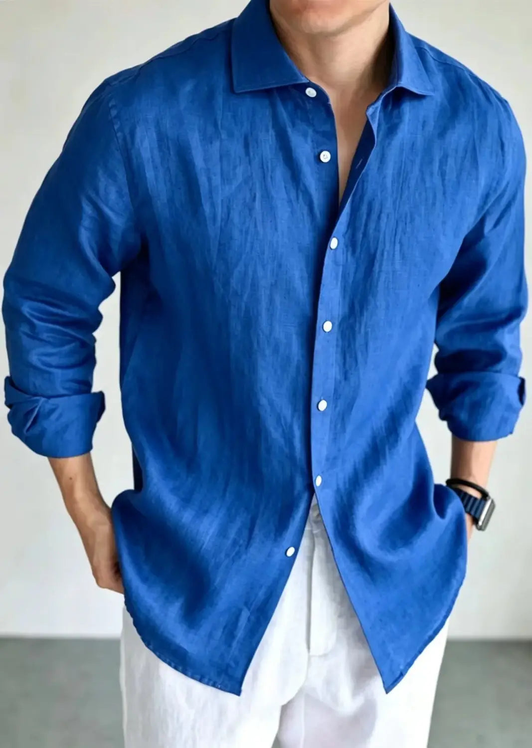 A rich royal blue men cotton linen casual button down shirt featuring long sleeves, a classic collar, and white buttons.