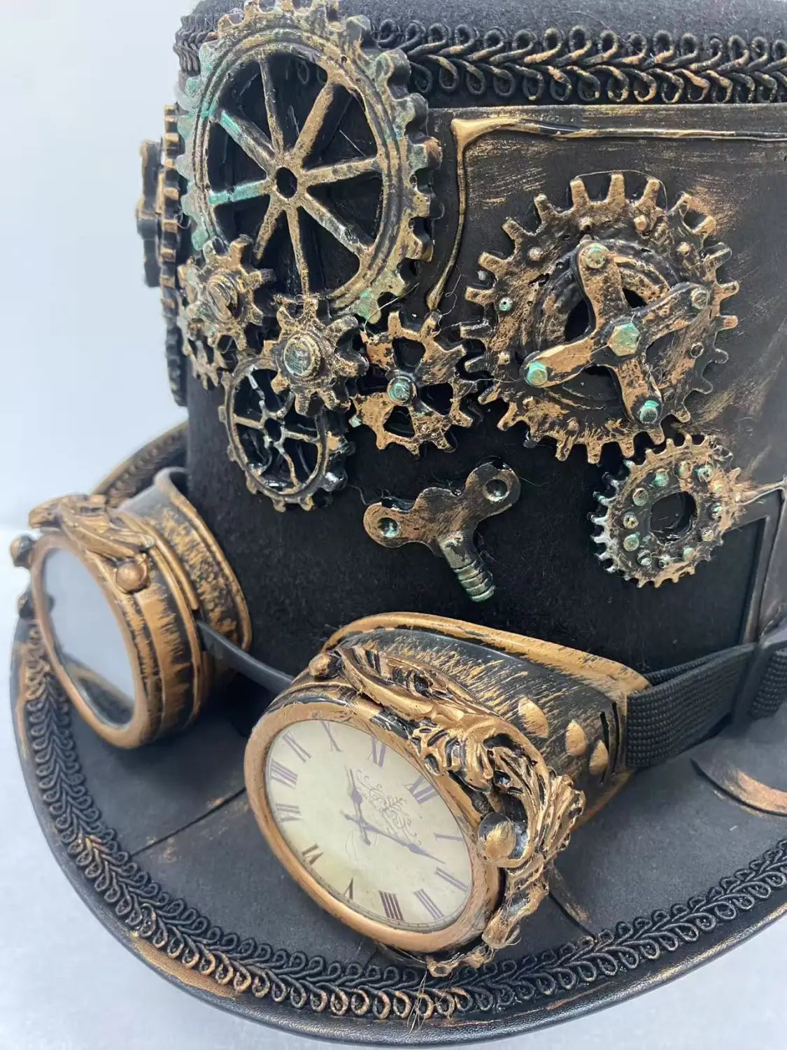 Steampunk top hat featuring brass and copper gears, a vintage clock face, and ornate goggles designed for stylish costume wear.