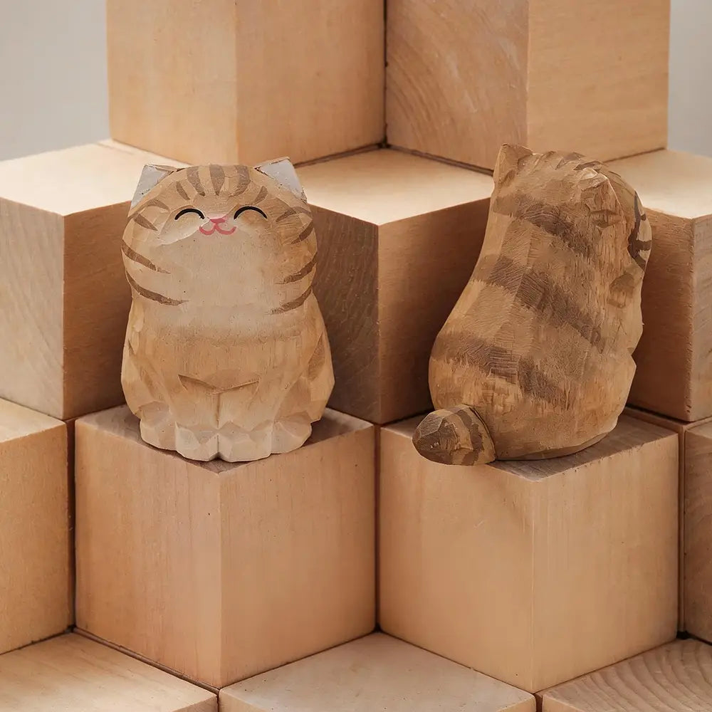 Two handcrafted wooden cat figurines featuring natural wood grain and striped patterns show an actual product from factory direct hand carved desk decor.