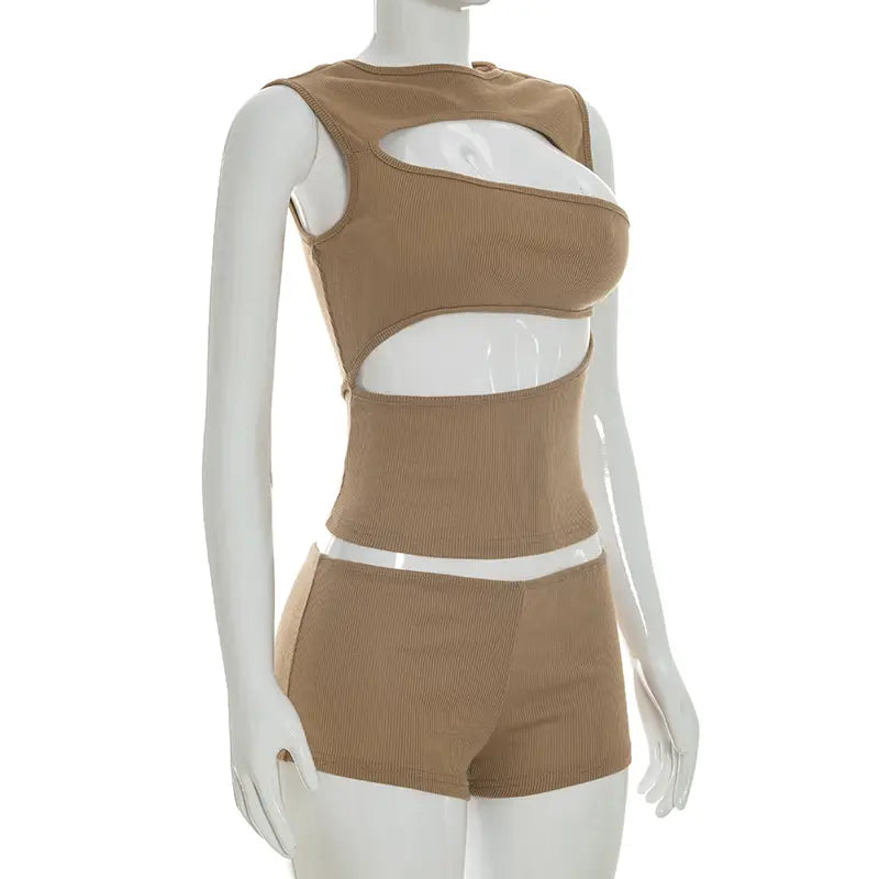 Tan ribbed knit two-piece set featuring white cutout accents including a tank top and shorts.