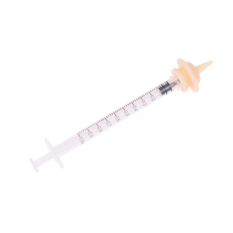 Clear plastic pet oral syringe feeding set with a beige silicone nipple attachment and black plunger for precise pet medication and feeding.