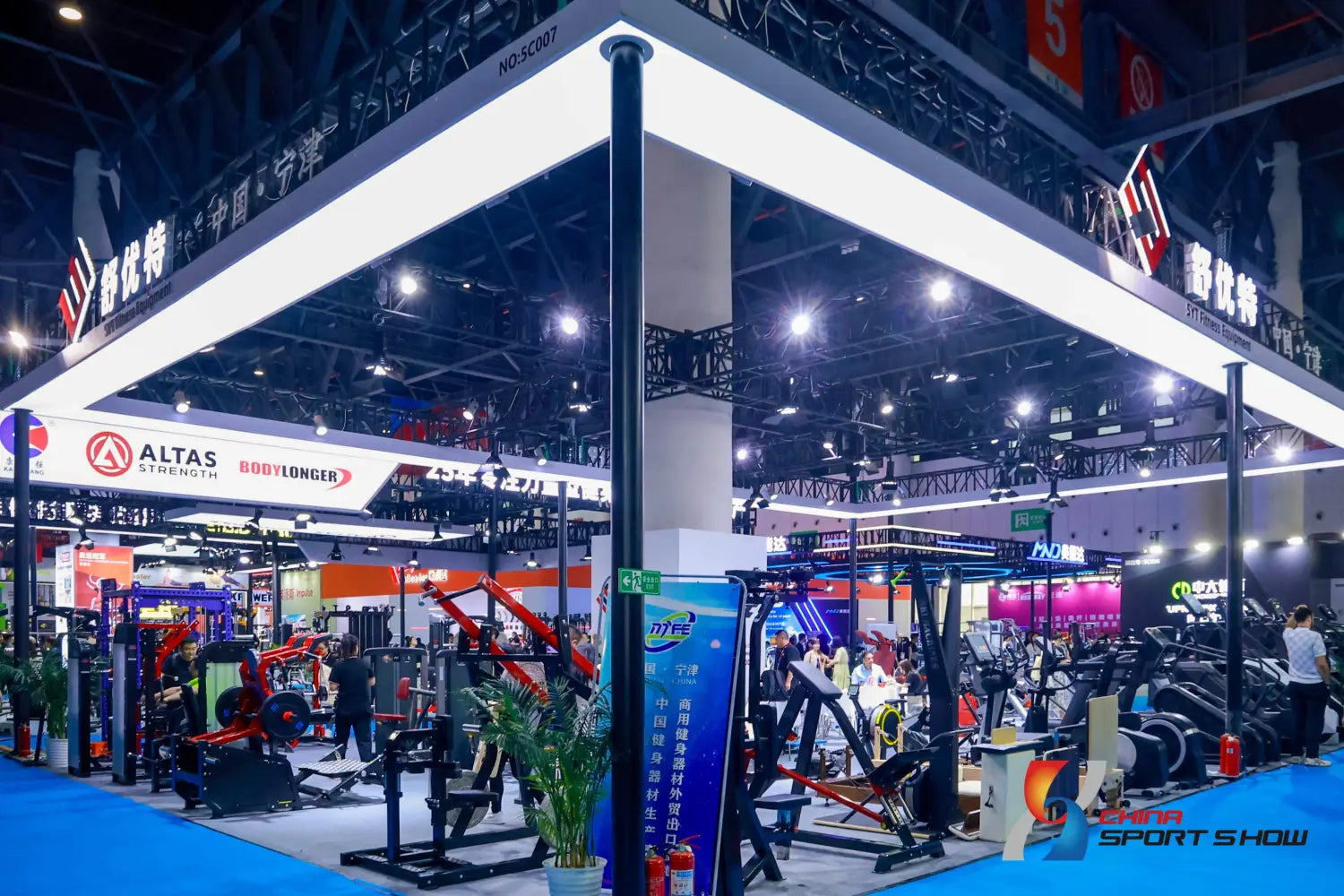 the altas strength commercial stair climber machine cardio stepmill is displayed among red and black weight machines under bright overhead lighting in a gym setting