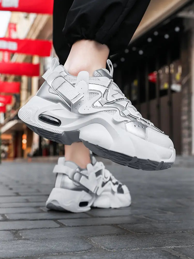 Men chunky air cushion casual sneakers in white and silver with a thick cushioned sole featuring black air units.
