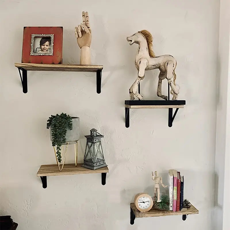 Des étagères murales flottantes en bois rustique avec des supports en métal noir servent de rangement fonctionnel et d’élément décoratif pour le salon.