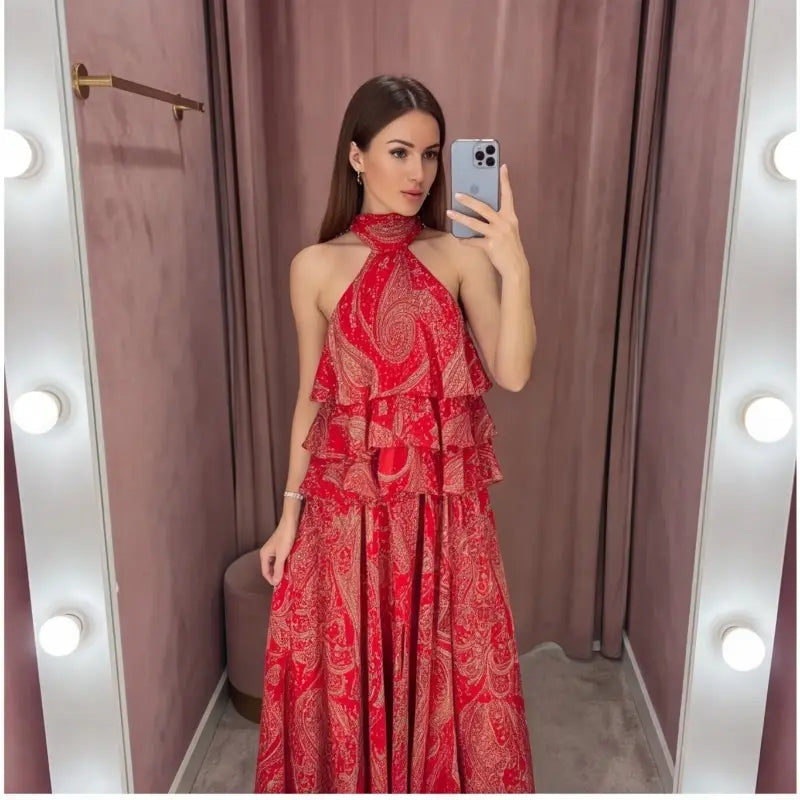 A vibrant red paisley halter top and midi skirt set featuring layered ruffles and intricate patterns.