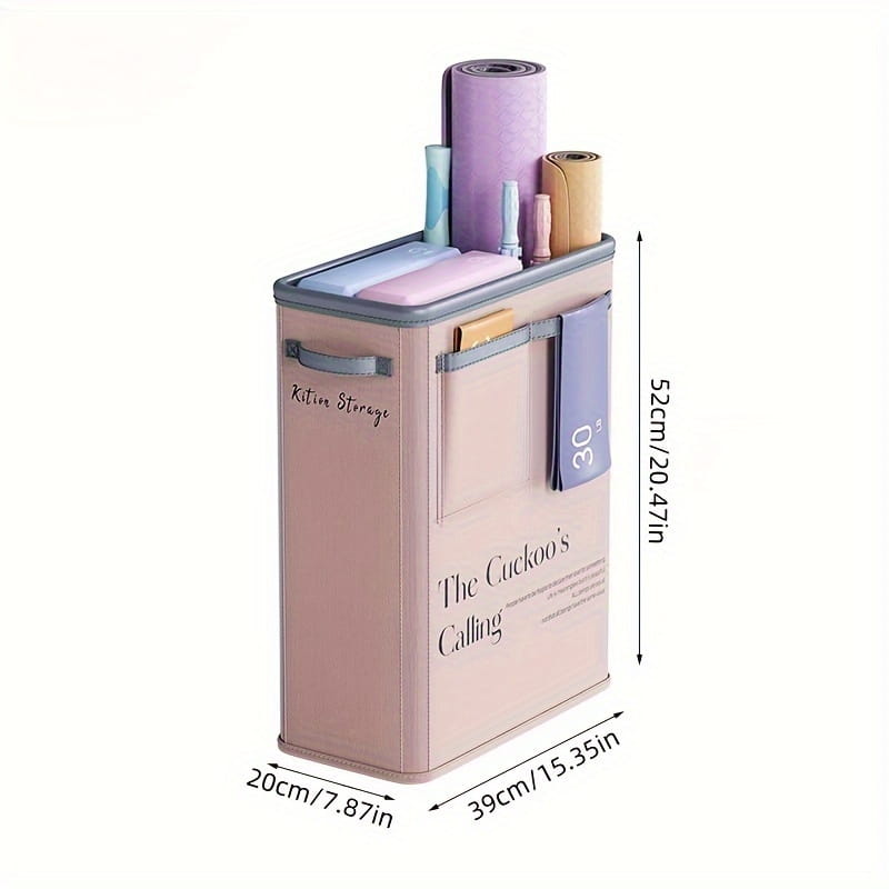 Pastel pink rectangular yoga mat storage basket with gray trim and handles featuring the cuckoos calling text on the front for fitness organization.