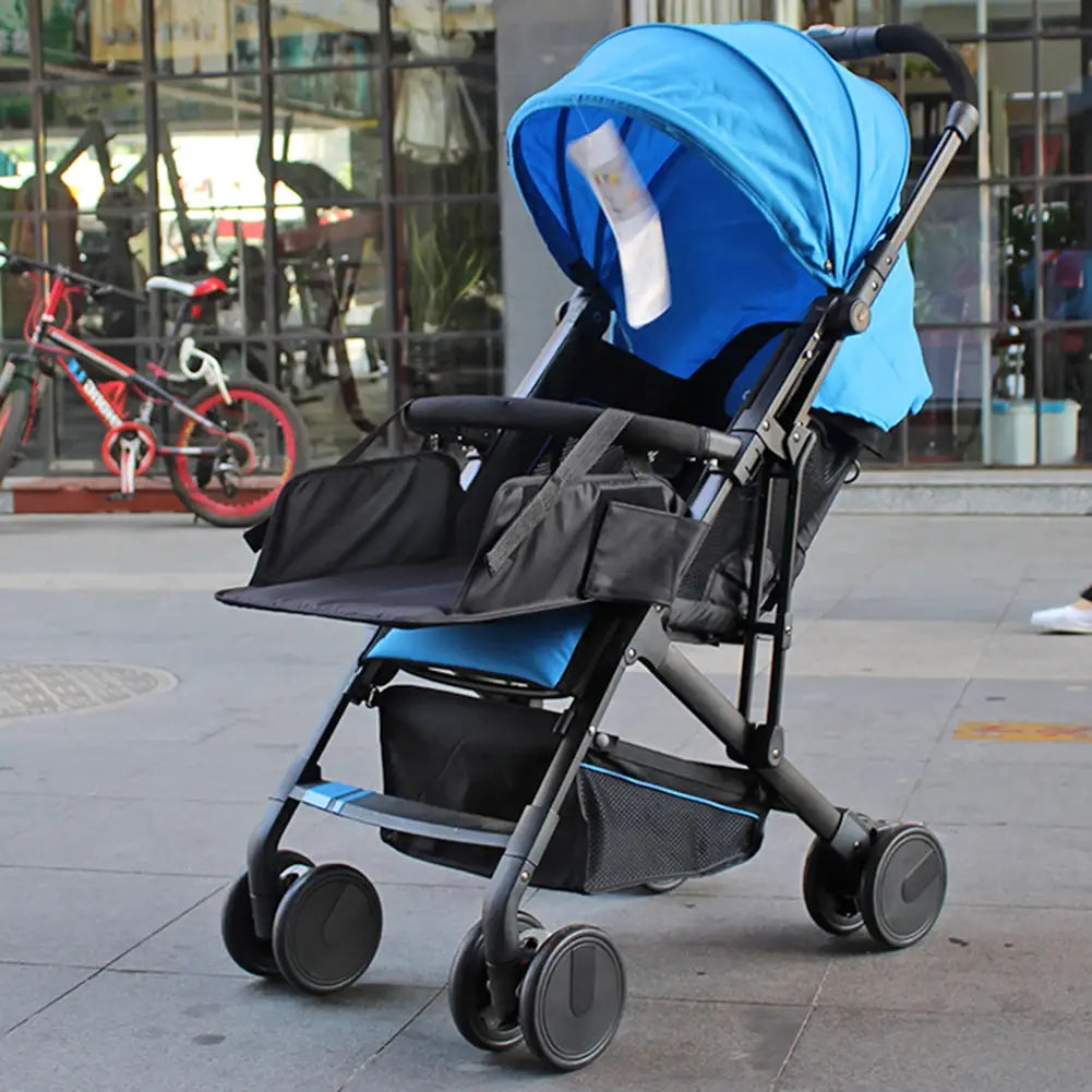 Blue and black foldable universal stroller extension footrest with canopy storage basket and multiple pockets shown from the back side.