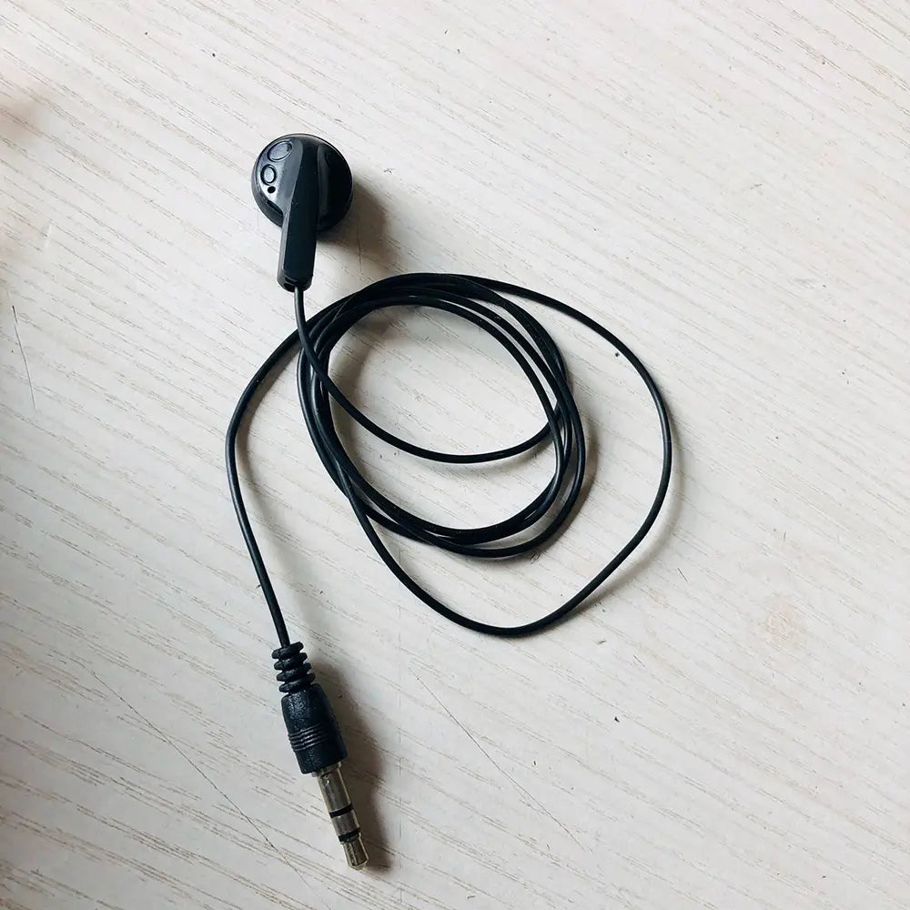 Écouteurs filaires noirs avec prise 3,5 mm et bouton de commande sur l’oreillette, conçus pour un usage stéréo intra-auriculaire simple avec mp3 mp4.