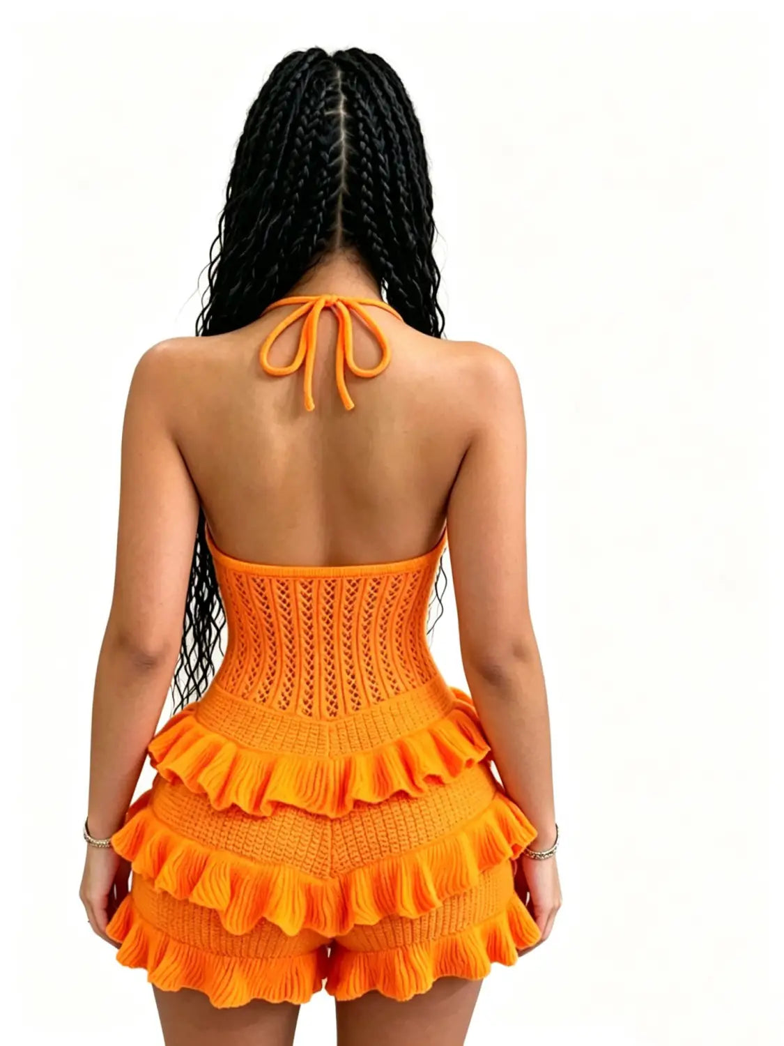 orange knitted halter romper with ruffled tiers and a tied back detail shown from the back for summer playsuit use