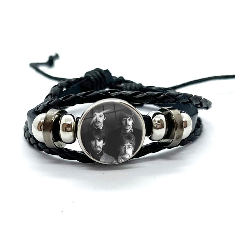Black braided leather bracelet with a circular silver-toned bezel holding a black and white photo of the Beatles under a glass dome.