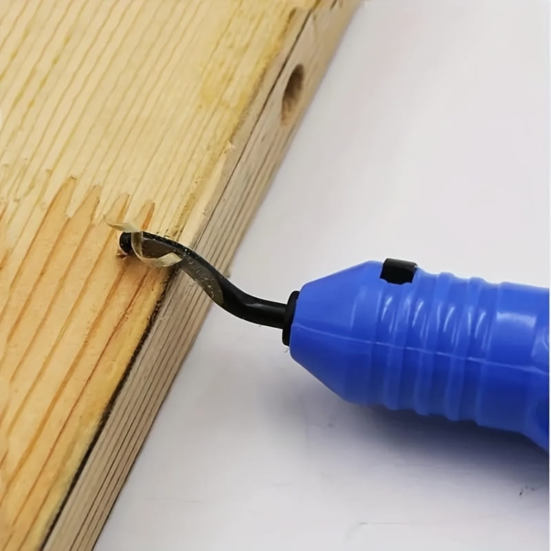 Blue plastic-handled resin epoxy trimming tool manual jewelry cutter with black metal blade removing wood shavings from a light-colored wooden board.