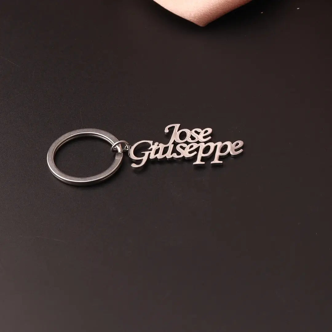 Silver metallic custom name keychain stainless steel gift featuring the name jose giuseppe in an elegant cursive font.