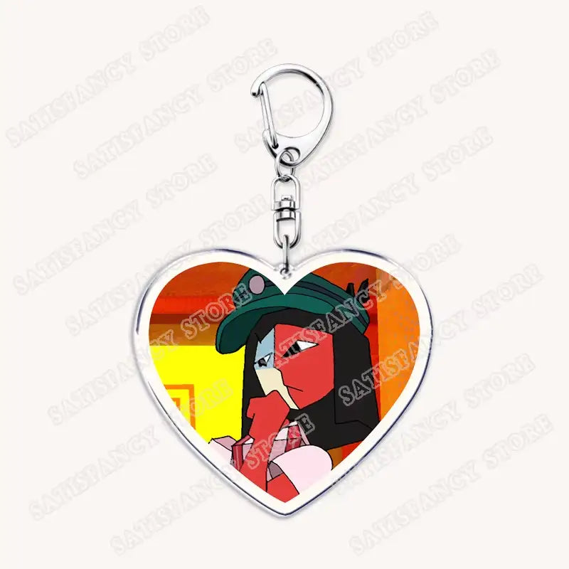 Herzförmiger Acryl-Schlüsselanhänger mit einem farbenfrohen Anime-Charakter mit roter und schwarzer Gesichtsfarbe und einer grünen Mütze, gestaltet als Geschenk für Gamer.