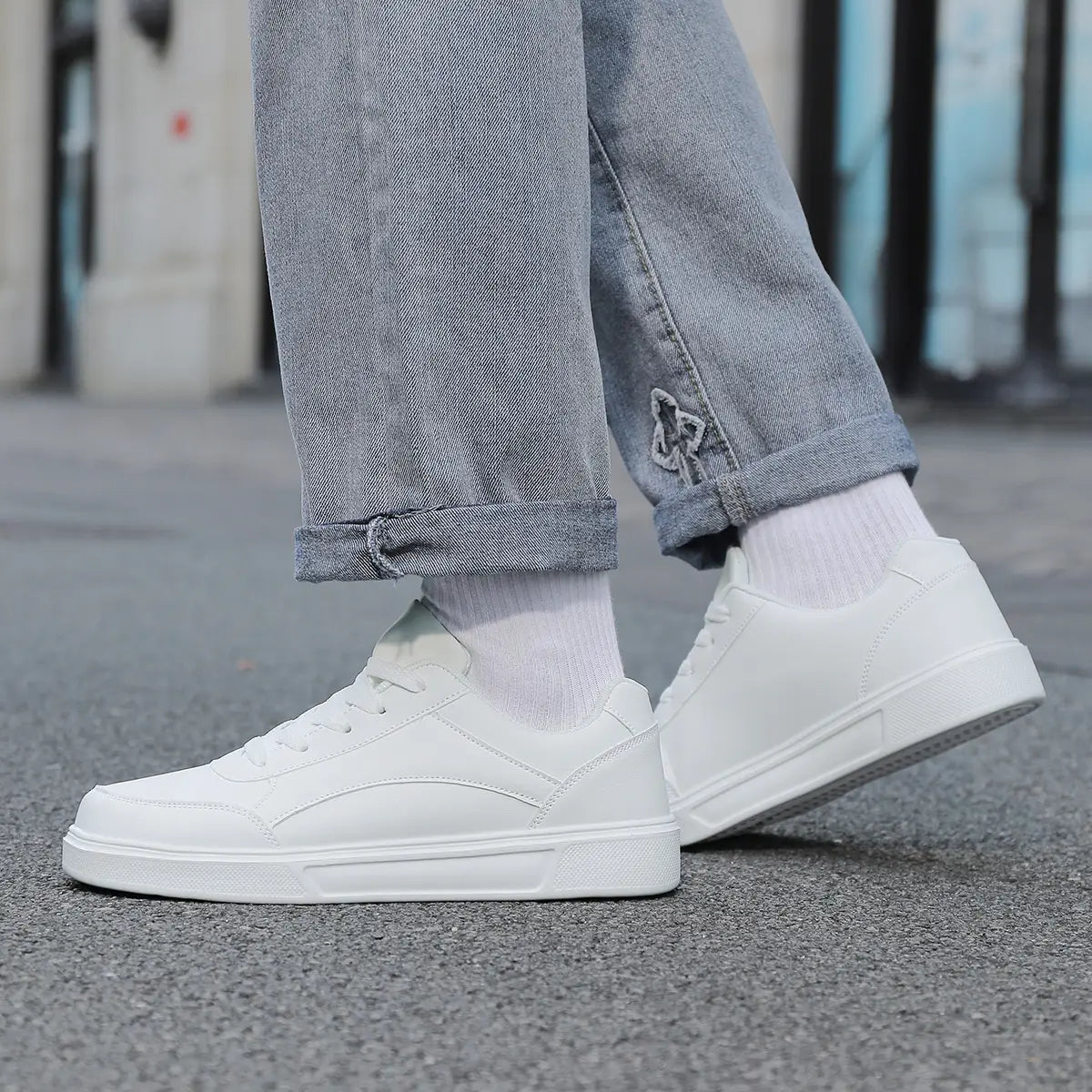 Men white leather minimalist low top sneakers featuring a clean design with smooth leather upper.