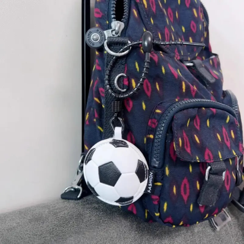 Leather sports ball keychain set bag charm featuring a white and black textured leather soccer ball attached to a backpack with a metal ring.