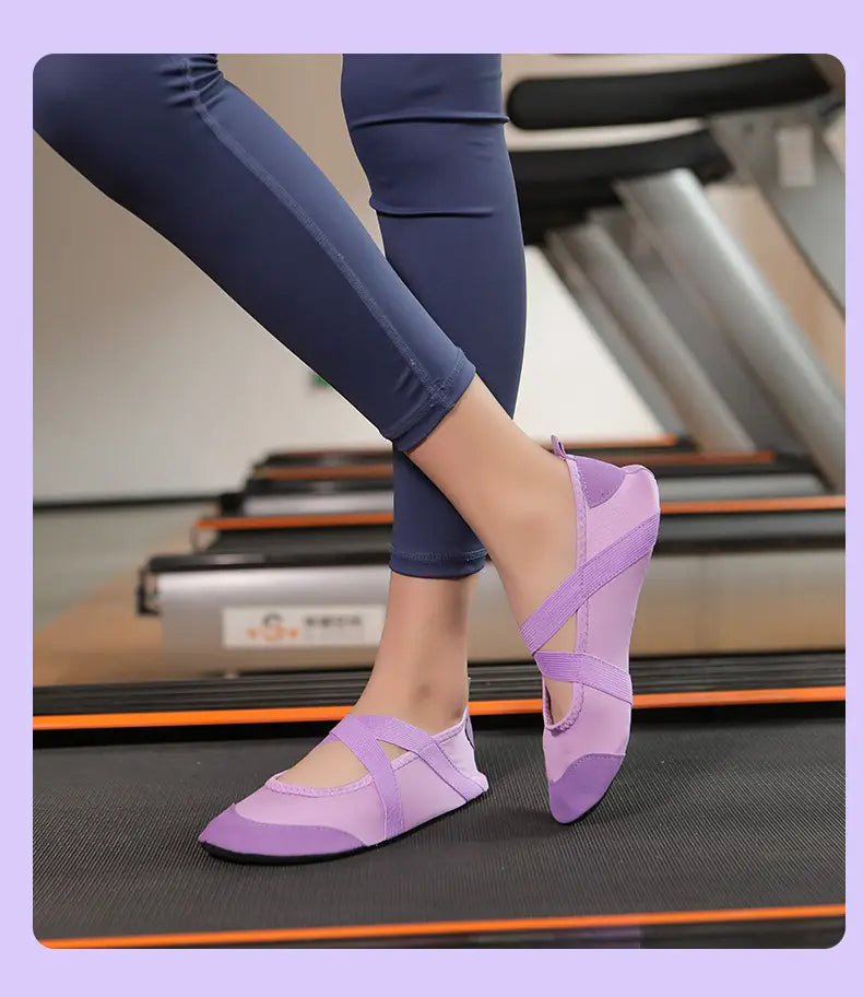 Women yoga shoes in purple with a cross-strap design featuring a soft flexible upper and rubberized toe cap for anti-slip fitness flats.