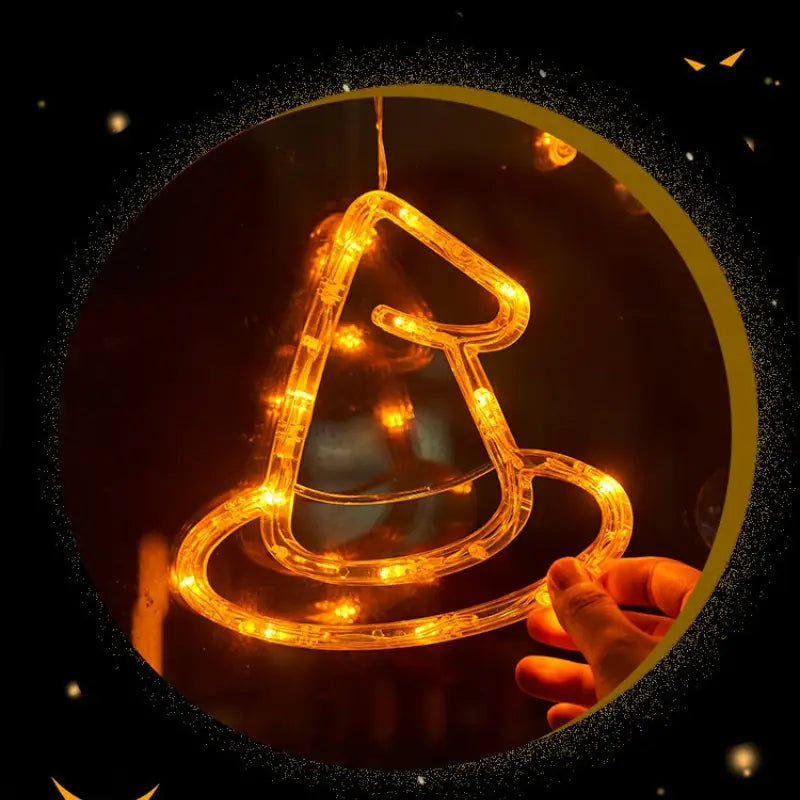a glowing orange led light-up witch hat decoration made of translucent plastic tubing for halloween window light battery operated pumpkin ghost decor