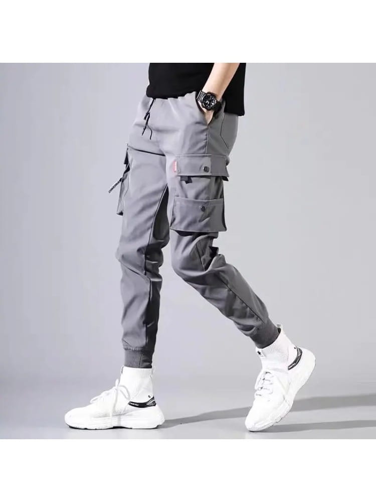 men tactical cargo pants in gray featuring multiple pockets and a tapered leg design ideal for versatile use.