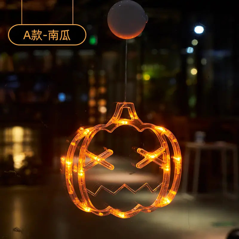 Orange led-lit battery operated pumpkin-shaped window decoration with suction cup top for Halloween ghost decor.