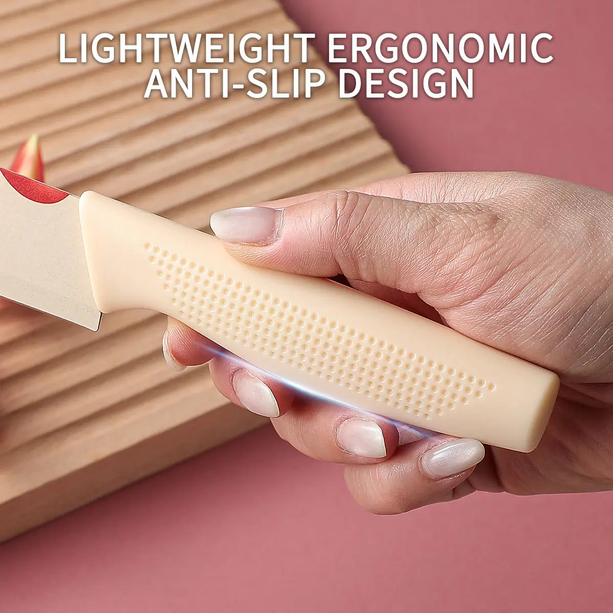 Cream-colored ceramic kitchen knife with ergonomic textured non-slip handle and red-tipped blade from the tomato pattern set.