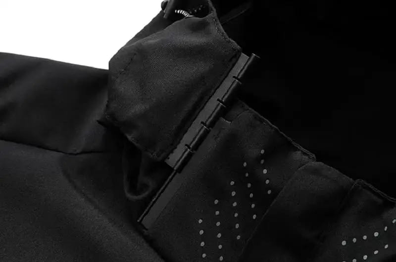 Men waterproof hiking jacket windbreaker outdoor hooded coat in black with subtle white dot pattern and sleek adjustable strap detail.